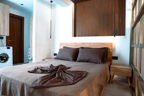 a bedroom with a bed with a blanket on it at Village Bliss in Kardamaina