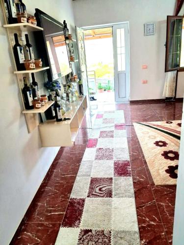 a room with a checkered floor and a room with a door at Villa Rexho in Berat