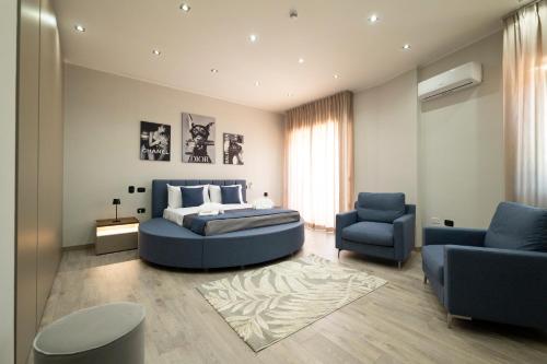 a bedroom with a blue bed and a blue chair at 3 torri GATEWAY in Maddaloni