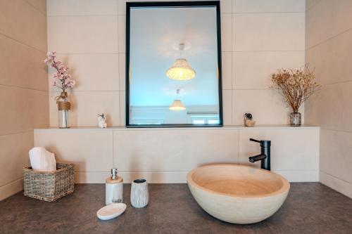 a bathroom with a large bath tub sitting under a window at LE JOLI BOIS in Colroy-la-Roche