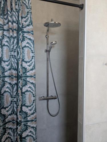 a shower in a bathroom with a shower curtain at Stubbekøbing City View Stopover in Stubbekøbing