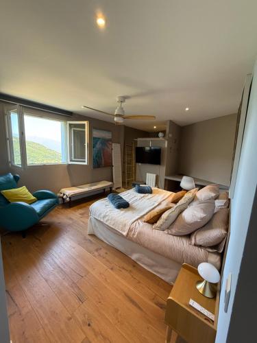 a large bedroom with a large bed and a chair at Casa Costa in Barbaggio
