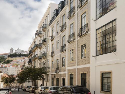 a row of buildings on a street with parked cars at LSA Castelo S Jorge by Numa in Lisbon