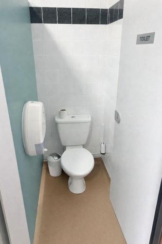 a bathroom with a toilet in a stall at Glamping Cabins in the Heart of Snowdonia in Dolgellau