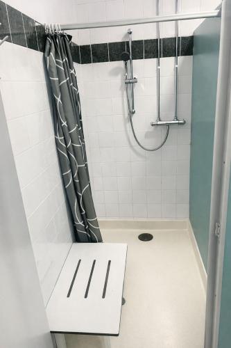 a bathroom with a shower with a shower curtain at Glamping Cabins in the Heart of Snowdonia in Dolgellau