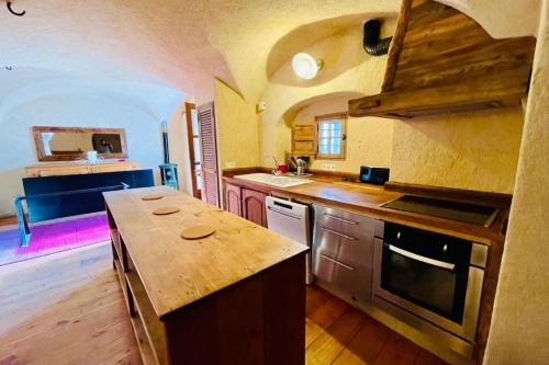 a large kitchen with a counter top and an island at 130 sqm Apartment in a Village House in La Salle-les-Alpes