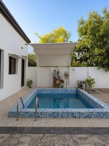 a pool in the backyard of a house at Al Rabi Rest House in Khor Fakkan
