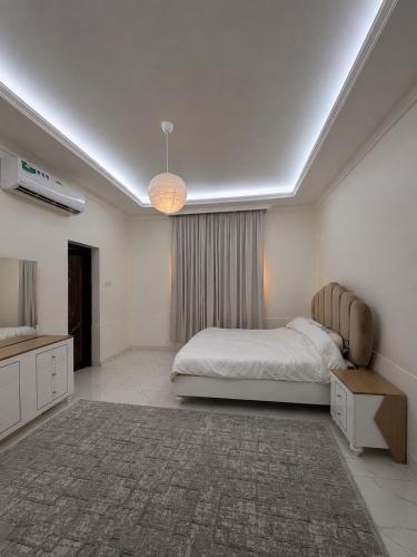 a bedroom with a bed and a television in it at Al Rabi Rest House in Khor Fakkan