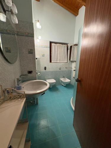 a bathroom with two toilets and a sink at Hotel Adria & Resort in Toscolano Maderno