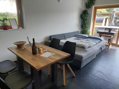 a living room with a couch and a wooden table at In den Bergen in Übersaxen
