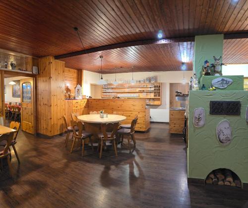 a dining room with a table and a refrigerator at Berggasthof Hinhart in Regen