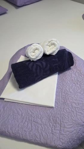 a pair of towels sitting on top of a bed at Apartman Koko with private jacuzzi in Makarska