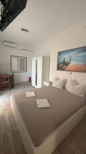 a bedroom with a large bed with a painting on the wall at Villa Berlin in Bol