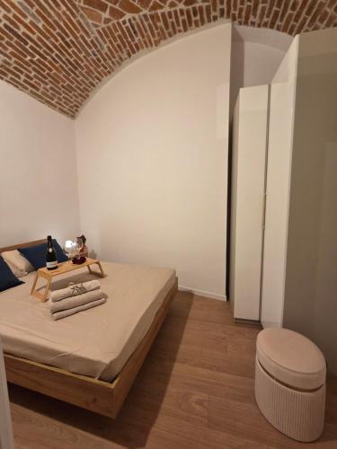 a bedroom with a bed and a white wall at UrbanSuite Torino in Turin