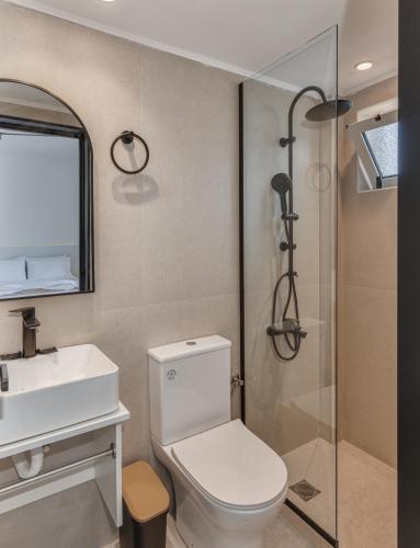 a bathroom with a toilet and a sink and a shower at Sunny Vibes by Estia Adults Only in Stalís