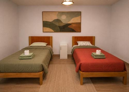two beds sitting next to each other in a room at MyAbancayHome in Abancay