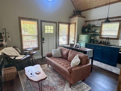 a living room with a couch and a kitchen at By the Docks Knox in Knoxville