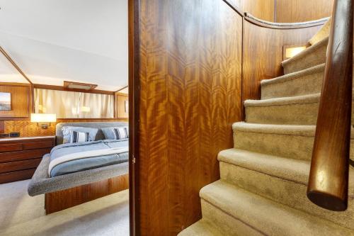 a stairway leading to a bedroom on a yacht at Klassische Motoryacht Ocean Motion in Flensburg
