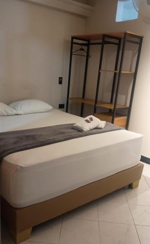 a bedroom with a bed and a bunk bed and shelves at Hotel Golden 70 in Medellín