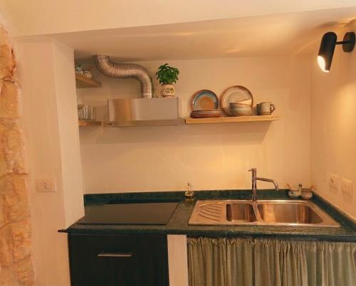 a kitchen with a sink and a counter top at SalentoTraTerraMare in Diso
