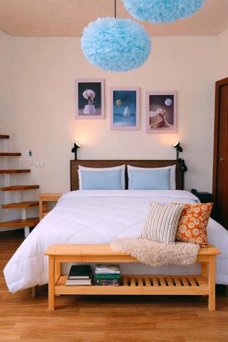 a bedroom with a large bed with a wooden bench at SalentoTraTerraMare in Diso