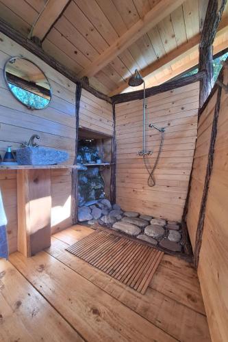 a bathroom with a shower and a sink at Hoopoe Glamping in Virpazar