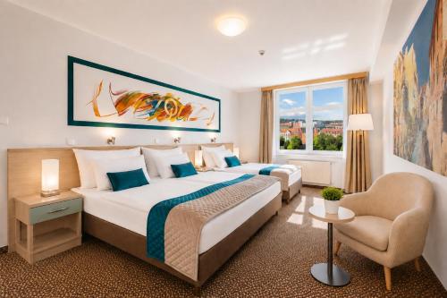 a hotel room with two beds and a chair at COLORFACTORY SPA Hotel - Czech Leading Hotels in Prague