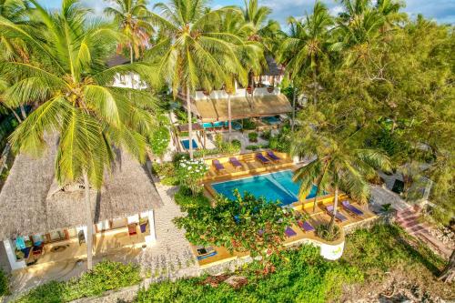 an aerial view of the resort with a swimming pool and palm trees at Mnana Beach Bungalows in Michamvi
