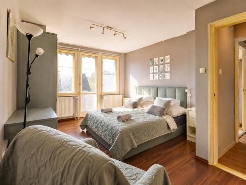 a bedroom with a bed and a lamp at Sefira Homes G in Keszthely