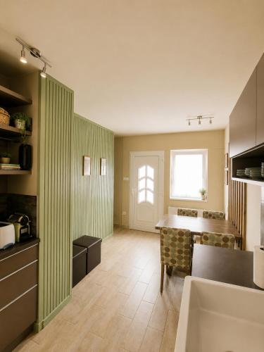 a room with a kitchen with a table and a window at Sefira Homes G in Keszthely
