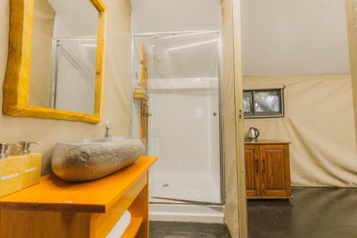 a bathroom with a sink and a mirror on a counter at The Explorers Camp in Renos