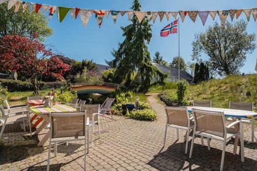 a patio with a table and chairs and a flag at Stavanger Urban Folkehøyskole in Stavanger