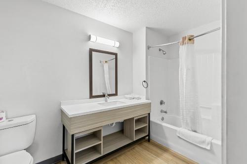 a white bathroom with a sink and a toilet at Suburban Studios Copley Akron West in Copley