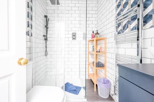 a white bathroom with a toilet and a sink at Charming Cottage, Lake District in Little Broughton
