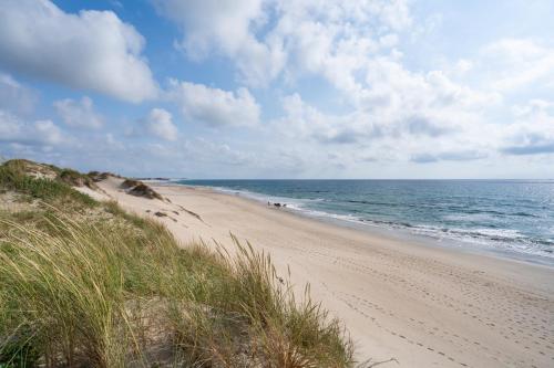 a beach with the ocean on a cloudy day at Seaside Beach Condo by Minho's Guest in Apúlia