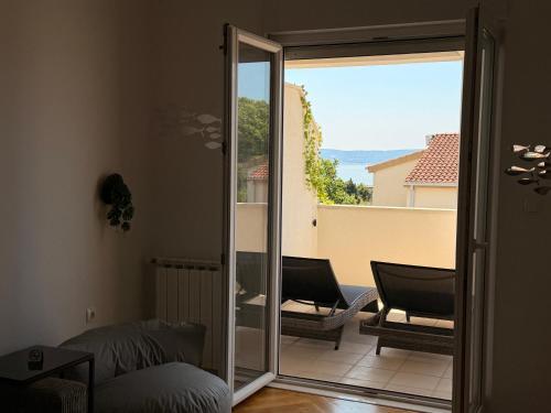 a room with a sliding glass door leading to a balcony at TIMO Apartment Split Croatia in Kaštela