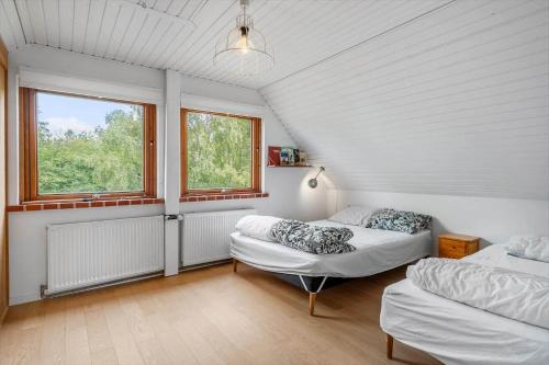 a bedroom with two beds and two windows at 4044-Borre-Klintholm-Havnevej-40 in Borre