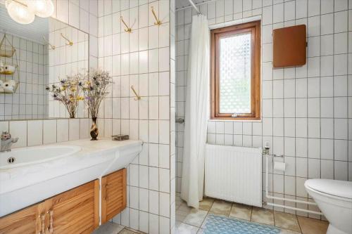 a bathroom with a sink and a toilet and a window at 4044-Borre-Klintholm-Havnevej-40 in Borre