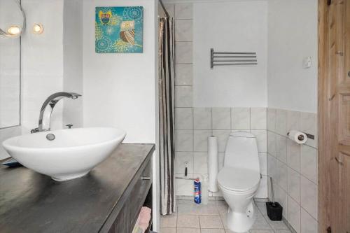 a bathroom with a white sink and a toilet at 6010-Askeby-Fanefjordgade-71 in Askeby