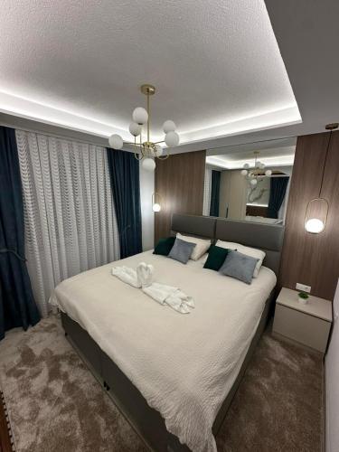 a bedroom with a large bed with towels on it at Centar Spa Teslic in Teslić