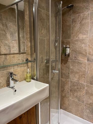 a bathroom with a sink and a shower at Old Field Barn Luxury B&B in Attleborough