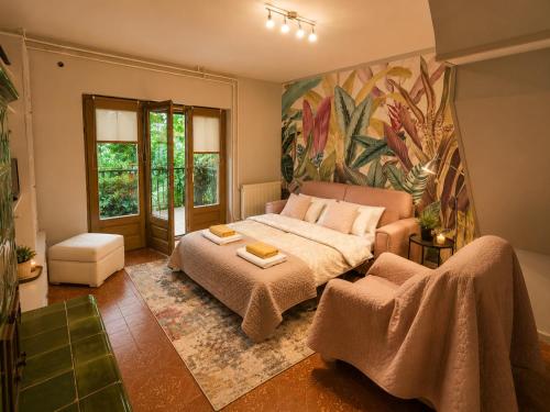 a bedroom with a bed and a painting on the wall at Sefira Homes Y in Keszthely