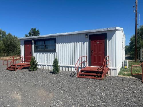 a small building with two chairs and a red door at Athens House number 7B in Las Vegas