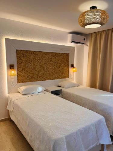 two beds in a hotel room with at Fotinos House Skiathos in Skiathos