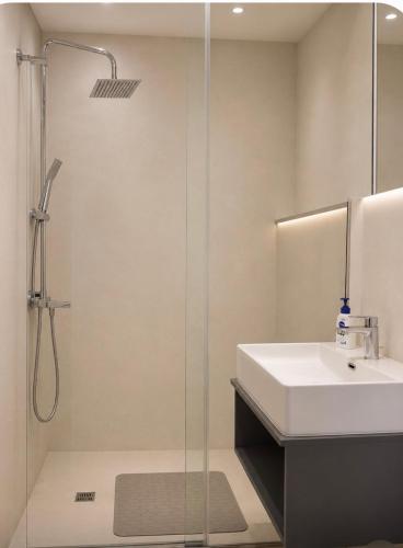 a bathroom with a sink and a shower at Kay-Stay in Larnaca