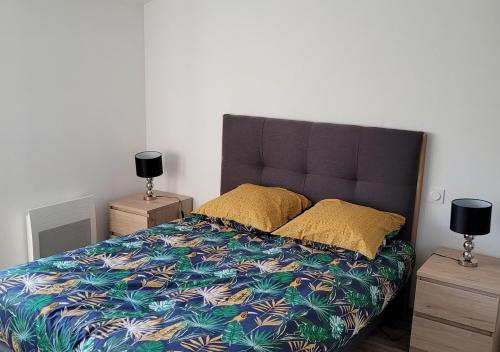 a bedroom with a large bed and two night stands at Le Logis du Donjon 2 in Les Herbiers