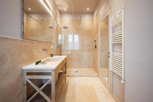 a bathroom with a sink and a shower at Relais dei Molini - Villa dei Molini in Castagneto Carducci