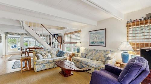 a living room with two couches and a staircase at Bethany West - 702 Radial Dr in Bethany Beach