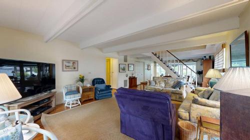 a living room with a couch and a tv at Bethany West - 702 Radial Dr in Bethany Beach