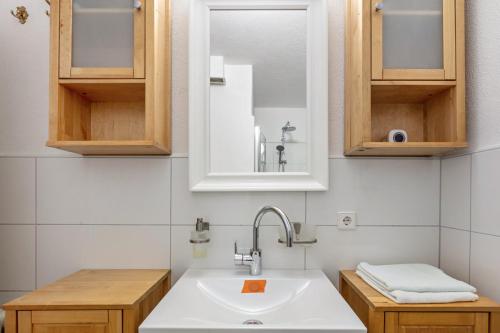 a kitchen with a sink and a mirror at Beautiful Apartment in Häusern